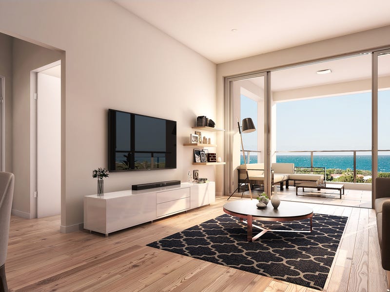 Light-filled apartment interior opening to an ocean-view balcony at Bel-Air at Beaches